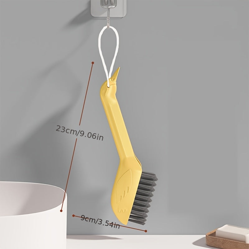 A Multifunctional Gap Cleaning Brush in a Cartoon Swan Design, Featuring a Head on The Handle That Can Be Used As a Spatula to Remove Stubborn Stains. It'S Suitable for Cleaning Stains in The Corners of Kitchens, Bathrooms, And Furniture
